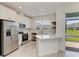 Modern kitchen showcasing stainless steel appliances, white cabinets, stylish backsplash, and eat in breakfast bar at 305 Via Tuscany Ave, Sarasota, FL 34243