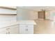 Open-concept living room connected to kitchen with tile flooring, modern ceiling fan, and a breakfast bar at 305 Via Tuscany Ave, Sarasota, FL 34243