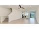 Open layout showcasing living space, staircase, and modern kitchen with stainless appliances at 305 Via Tuscany Ave, Sarasota, FL 34243