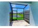 Screened patio with brick pavers overlooking a pond and neighboring houses at 305 Via Tuscany Ave, Sarasota, FL 34243
