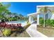 Community pool area with sun loungers, clubhouse, and lush landscaping, perfect for relaxation at 305 Via Tuscany Ave, Sarasota, FL 34243