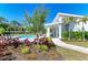 Community pool with sun loungers, clubhouse, and manicured landscaping, ideal for leisure at 305 Via Tuscany Ave, Sarasota, FL 34243