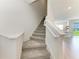 Carpeted staircase with white trim and modern design, leading to the upper level of the home at 305 Via Tuscany Ave, Sarasota, FL 34243