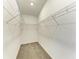 Walk-in closet featuring ample storage with wire shelving and neutral carpet at 305 Via Tuscany Ave, Sarasota, FL 34243
