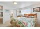 Bright bedroom with floral bedding, and a mirrored closet door at 3214 Sycamore Ter, Sarasota, FL 34237