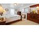 Cozy bedroom with natural light, a comfortable bed and vintage wood furniture at 3214 Sycamore Ter, Sarasota, FL 34237