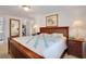 Warm, cozy bedroom with wood furniture and a view to a laundry room and bathroom at 3214 Sycamore Ter, Sarasota, FL 34237