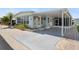 Charming single-story home featuring a covered parking area, quaint front garden, and brick-paved pathways at 3214 Sycamore Ter, Sarasota, FL 34237