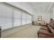 A sun-filled living room with carpet flooring, white walls, and bright windows at 3214 Sycamore Ter, Sarasota, FL 34237