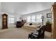 Comfortable living room with a grandfather clock, lots of light, and plush seating at 3214 Sycamore Ter, Sarasota, FL 34237