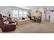Spacious living area with comfortable furniture, neutral carpet, and bright natural lighting at 3214 Sycamore Ter, Sarasota, FL 34237