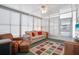 Bright sunroom with comfortable seating, fan, and lots of light from the many white-shuttered windows at 3214 Sycamore Ter, Sarasota, FL 34237