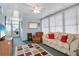 Cozy living room with lots of light, comfortable seating, ceiling fan and a colorful rug at 3214 Sycamore Ter, Sarasota, FL 34237