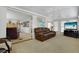 Comfortable living room featuring neutral carpeting, a ceiling fan, and a comfortable leather sofa at 3214 Sycamore Ter, Sarasota, FL 34237