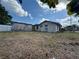 Backyard featuring the shed and the rear exterior of the house in disrepair at 322 34Th W St, Bradenton, FL 34205