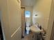 Functional bathroom with a pedestal sink, toilet, and shower, designed for essential needs at 322 34Th W St, Bradenton, FL 34205