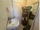 Compact bathroom with a sink, mirror, and water heater, designed to maximize utility in a limited space at 322 34Th W St, Bradenton, FL 34205