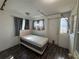 Bedroom with gray walls, wood floors, a small bed, and a window that allows natural light at 322 34Th W St, Bradenton, FL 34205