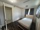 Bedroom with gray walls, wood floors, a small bed, and a window that allows natural light at 322 34Th W St, Bradenton, FL 34205