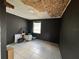Small, partially renovated bedroom with black walls, tiled flooring, and updated lighting at 322 34Th W St, Bradenton, FL 34205