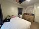 Comfortable bedroom with decor, a dresser and ample space for relaxation, enhancing personal comfort at 322 34Th W St, Bradenton, FL 34205