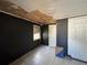 Small, partially renovated bedroom with black walls, tiled flooring, and updated lighting at 322 34Th W St, Bradenton, FL 34205