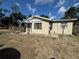 A single-story home with a covered porch and muted beige exterior, complemented by a small garden at the front at 322 34Th W St, Bradenton, FL 34205