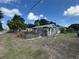 Small home with chain link fence in the front yard surrounded by dry foliage at 322 34Th W St, Bradenton, FL 34205