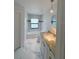 Modern bathroom featuring a luxurious bathtub, a sleek vanity with granite countertops, and stylish tile flooring at 3386 Irma St, North Port, FL 34291