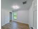 Bright bedroom with wood-look flooring, a modern ceiling fan, and a window offering natural light at 3386 Irma St, North Port, FL 34291