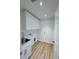 Efficient laundry room with modern sink and cabinets, plus practical vinyl flooring and a convenient exterior door at 3386 Irma St, North Port, FL 34291