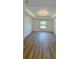 Spacious main bedroom featuring wood-look floors, tray ceilings and abundant natural light from the large window at 3386 Irma St, North Port, FL 34291