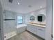 Modern bathroom featuring double vanities, soaking tub, glass-enclosed shower, and stylish tile at 3398 Escobar Ln, North Port, FL 34286