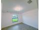 Bright bedroom with tile floors and modern light fixture at 3398 Escobar Ln, North Port, FL 34286