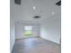 Spacious bedroom with large window offering ample natural light and tile floors at 3398 Escobar Ln, North Port, FL 34286