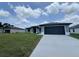 Beautiful single-story home featuring a well-manicured lawn and attached two-car garage at 3398 Escobar Ln, North Port, FL 34286