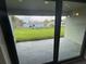 View from interior onto the backyard from the tiled outdoor patio area at 3398 Escobar Ln, North Port, FL 34286