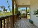 Back porch showcasing wood floors, railing, views of greenery, plants, and backyard at 3828 6Th W Ave, Palmetto, FL 34221