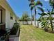 Enjoy a private backyard with tropical foliage, palm trees, and a white fence at 3828 6Th W Ave, Palmetto, FL 34221
