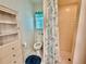 Bathroom featuring a toilet, tiled walk-in shower, and a storage cabinet for essentials at 3828 6Th W Ave, Palmetto, FL 34221