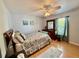 Bright bedroom with a ceiling fan, wood floors, a large mirror, and window with curtains at 3828 6Th W Ave, Palmetto, FL 34221