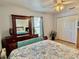 Comfortable bedroom featuring a ceiling fan, wood floors, mirror, curtains, and closet at 3828 6Th W Ave, Palmetto, FL 34221