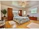 Primary bedroom with wood floors, ceiling fan, a window, and access to a backyard door at 3828 6Th W Ave, Palmetto, FL 34221