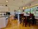 Dining area open to kitchen with wood floors, chairs, and a view to the backyard at 3828 6Th W Ave, Palmetto, FL 34221