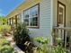 Charming exterior view with siding, window trim, plants, and a quaint front porch at 3828 6Th W Ave, Palmetto, FL 34221