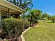 Charming home exterior with lush landscaping, tropical plants, and inviting curb appeal under a sunny sky at 3828 6Th W Ave, Palmetto, FL 34221