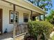 Charming front porch with seating, landscaping, and the home's number on the posts at 3828 6Th W Ave, Palmetto, FL 34221