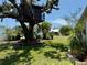 Expansive front yard featuring a large treehouse and lush green lawn at 3828 6Th W Ave, Palmetto, FL 34221