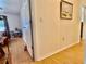 Hallway with wood-look flooring and access to a bedroom, showcasing the home's layout at 3828 6Th W Ave, Palmetto, FL 34221
