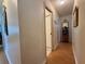 Hallway featuring wood-look flooring, a closet with sliding doors, and decorative shelving at 3828 6Th W Ave, Palmetto, FL 34221